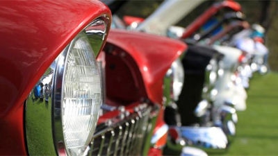 View of vintage car's headlights and open bonnets